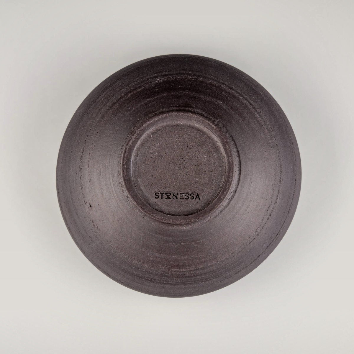 Flat overhead view of ceramic bowl with unique glaze effect and soft circular foot.