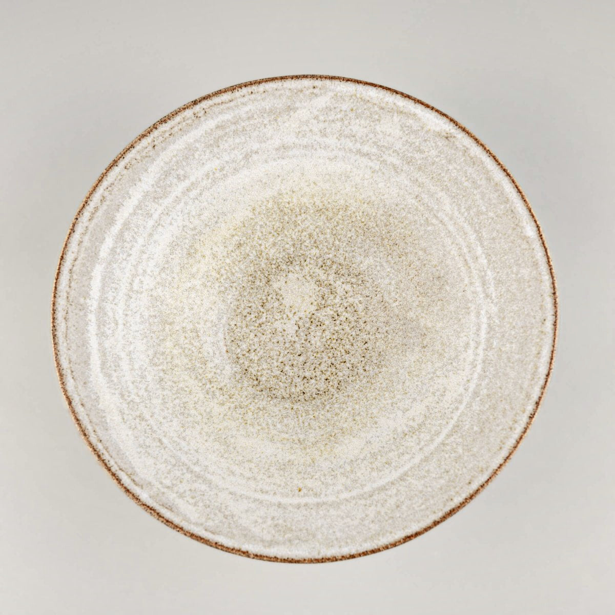 Top-down view of a handmade ceramic bowl showing smooth glazed interior and wide rim.