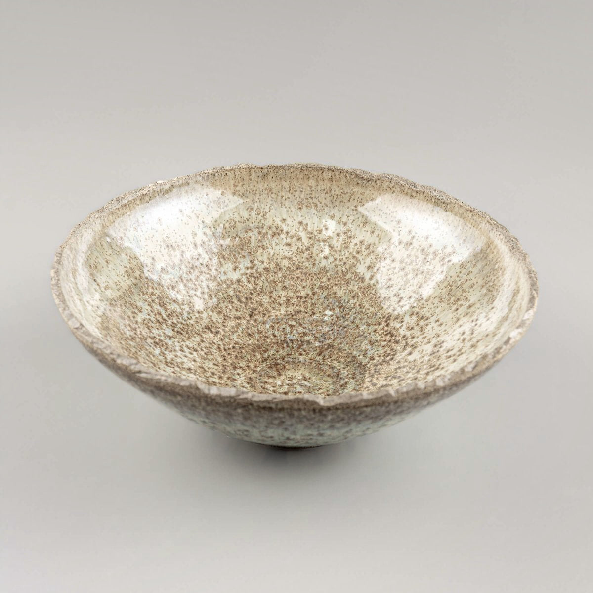Side view of handcrafted ceramic bowl in stoneware with smooth glaze and modern silhouette.