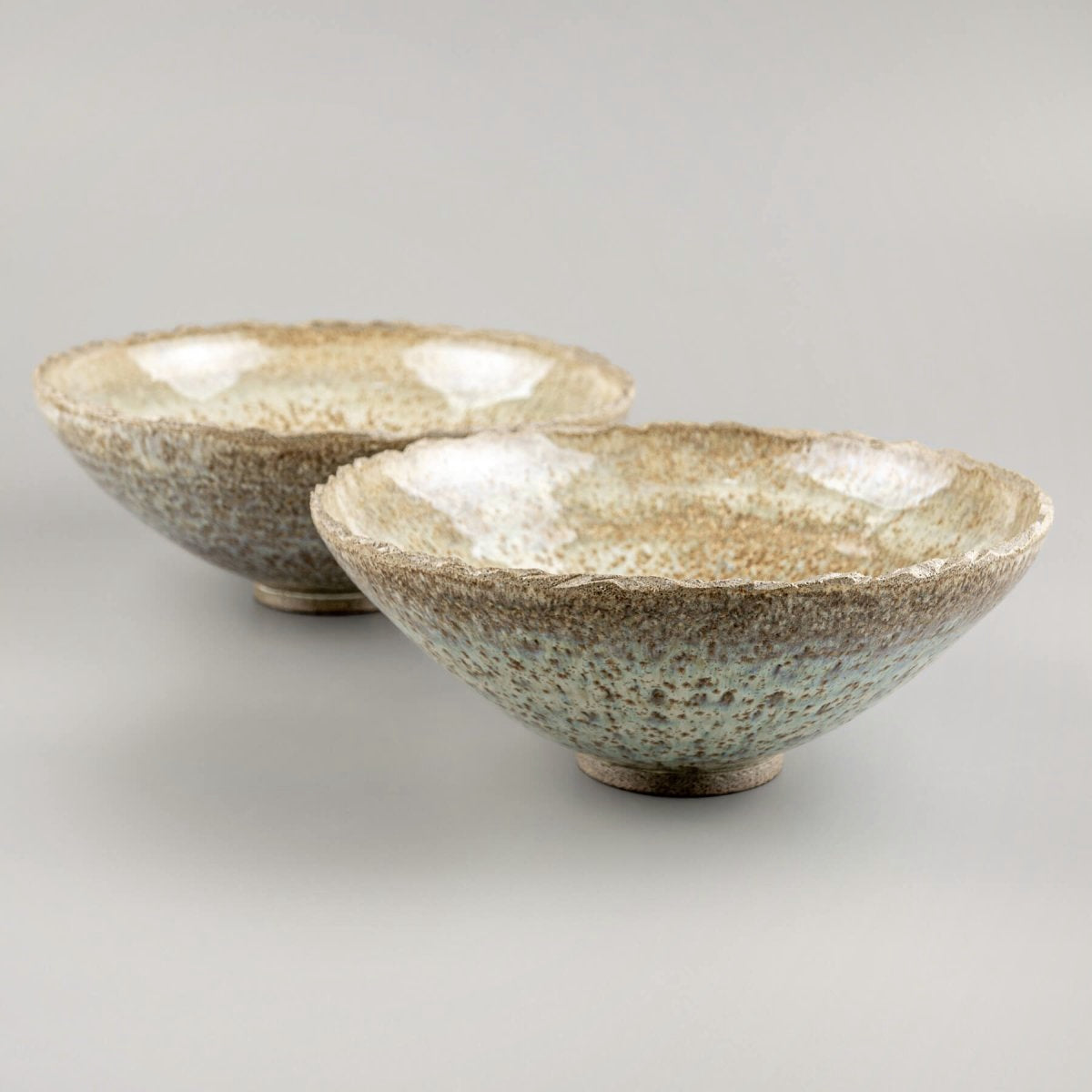Set of artisan ceramic bowls with natural glaze, perfect for rustic interior decor or functional use.