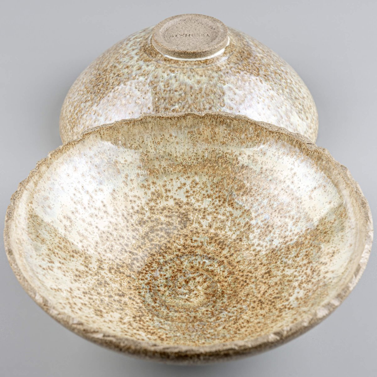 Set of artisan ceramic bowls with natural glaze, perfect for rustic interior decor or functional use.
