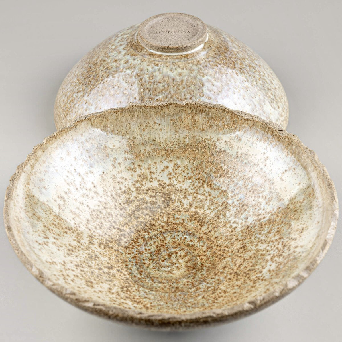 Set of artisan ceramic bowls with natural glaze, perfect for rustic interior decor or functional use.