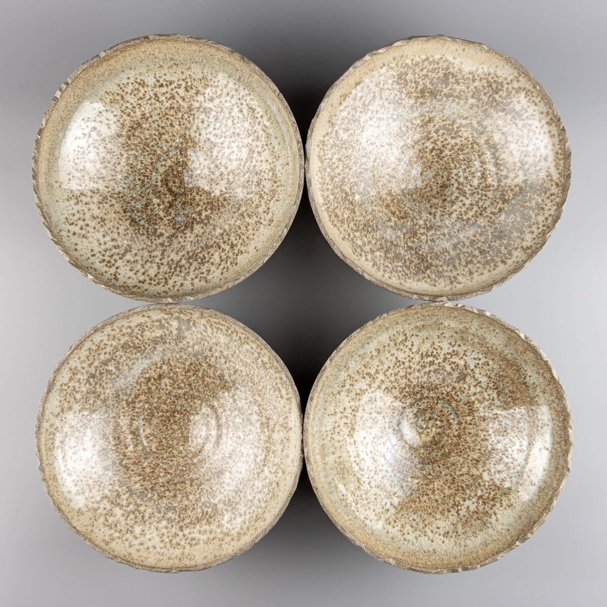 Stacked handmade ceramic bowls crafted from durable stoneware with tactile, organic finish.