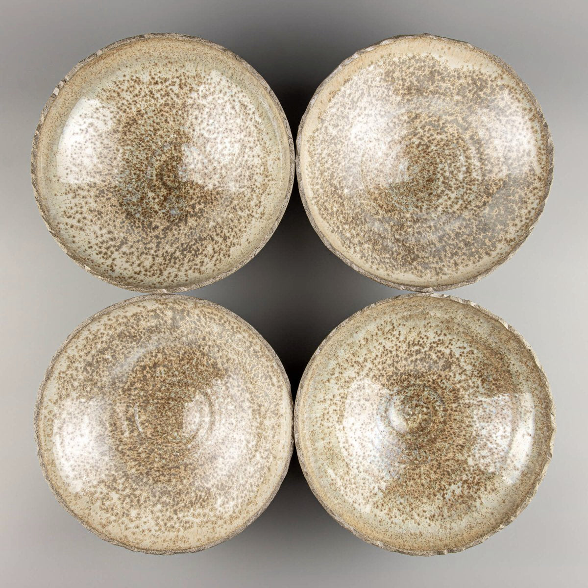 Stacked handmade ceramic bowls crafted from durable stoneware with tactile, organic finish.