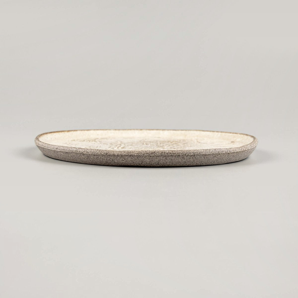 Chef holding small artisan plate, perfect for culinary presentation or restaurant use.