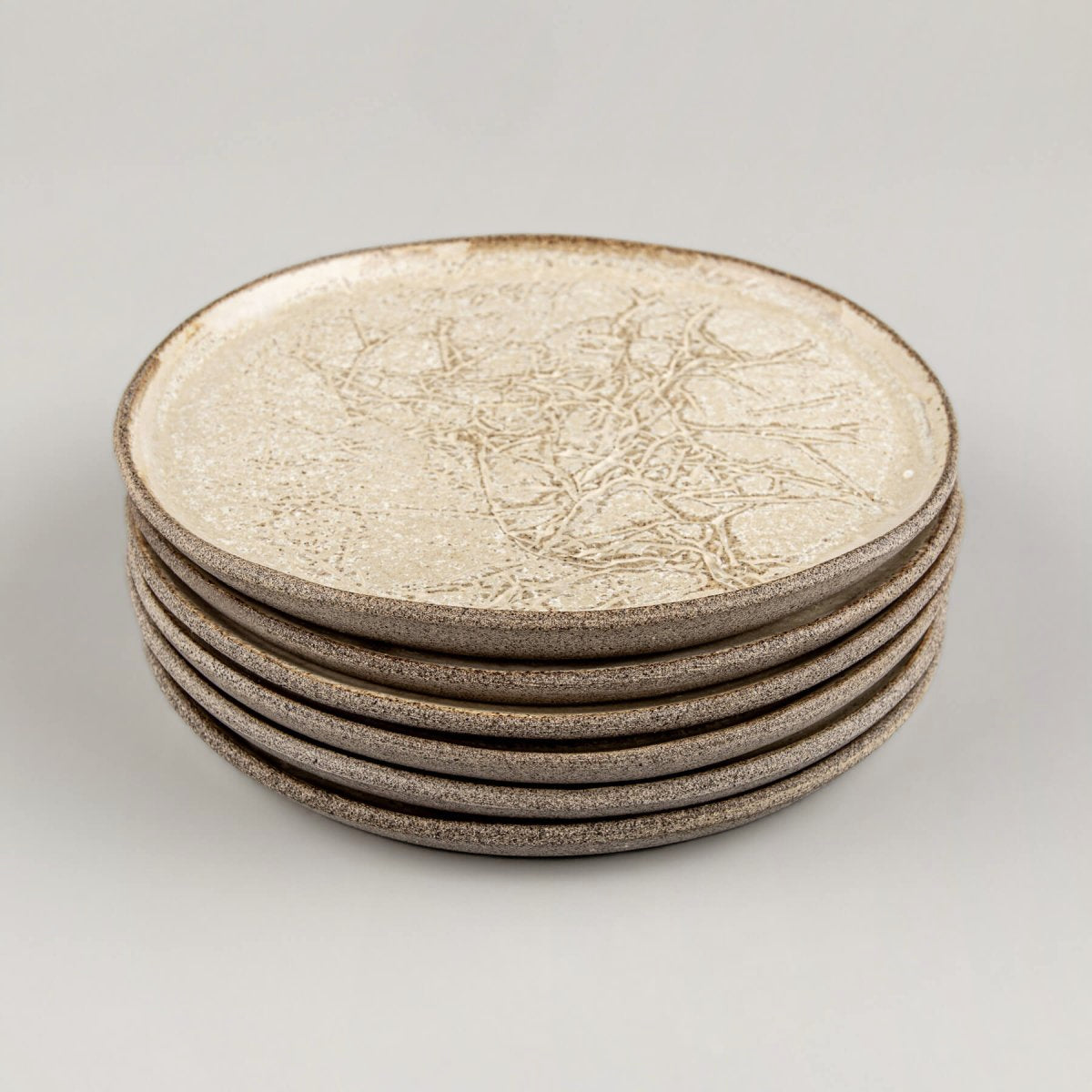 Stoneware plates stacked for kitchenware or collectible pottery display.