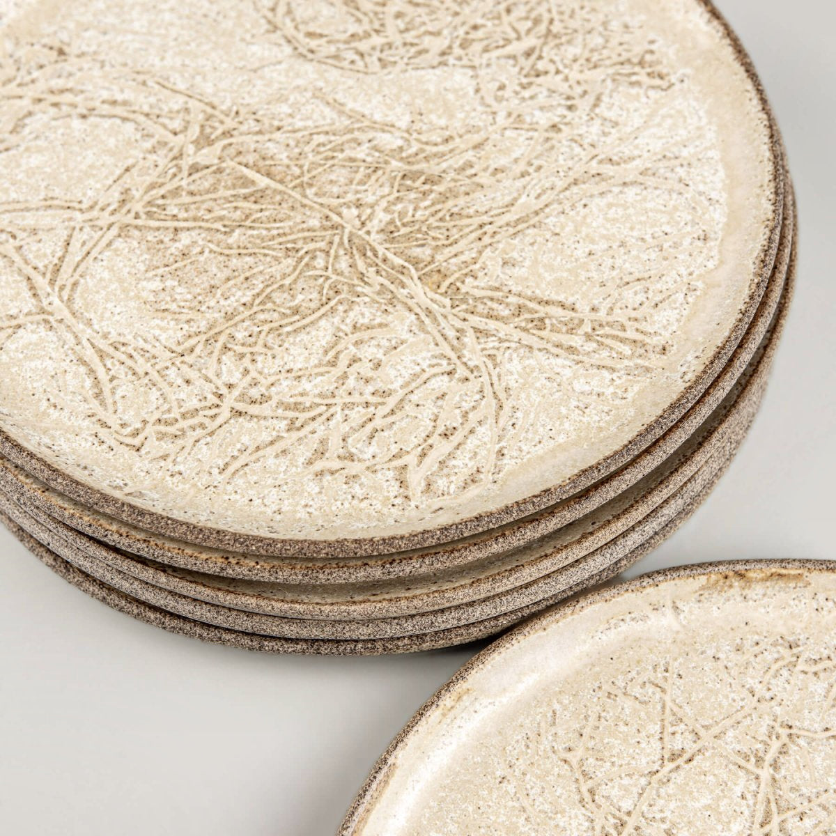 Stoneware plates stacked for kitchenware or collectible pottery display.