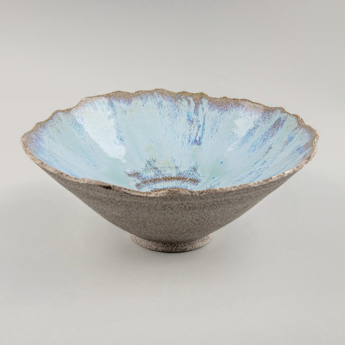 Front perspective of handcrafted stoneware serving bowl highlighting glazed interior.