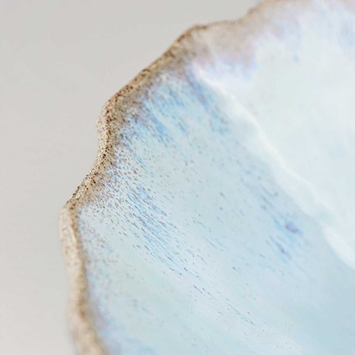 Flat lay showing the wide rim and inner spiral design of handmade ceramic dish.