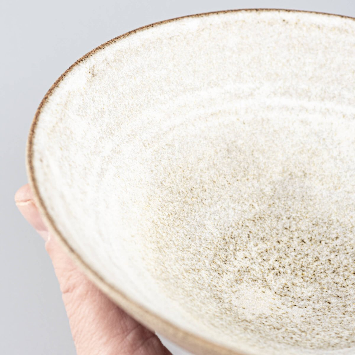 Interior close-up showing glazing pattern and craftsmanship of handmade ceramic bowl.