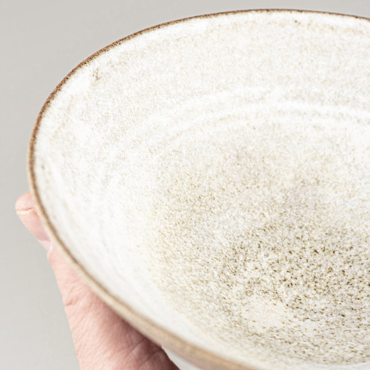Interior close-up showing glazing pattern and craftsmanship of handmade ceramic bowl.