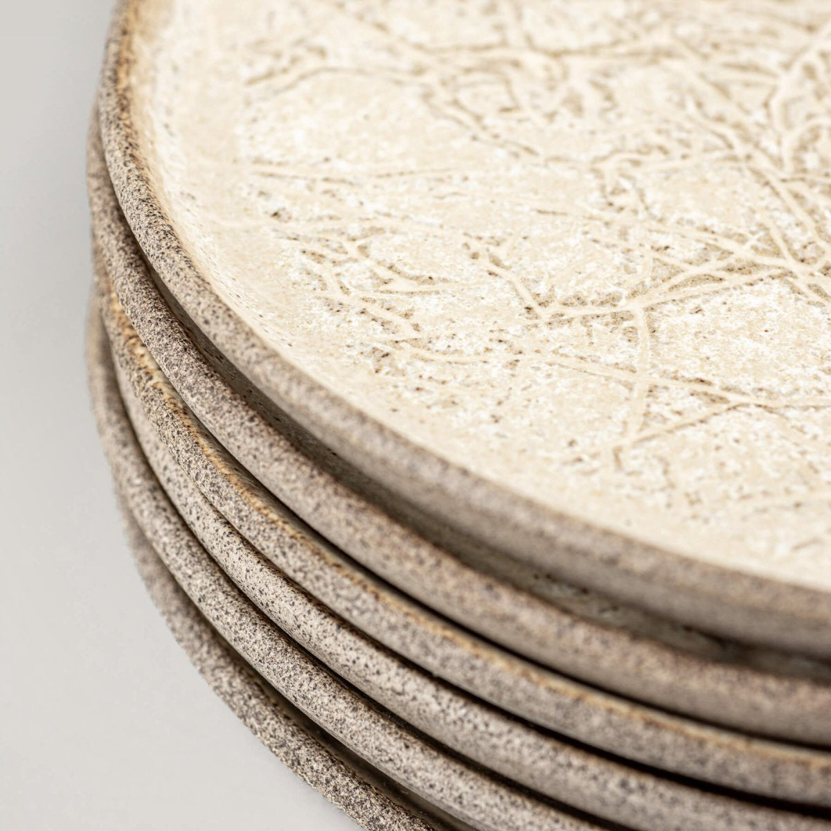 Detail of hand-textured matte ceramic plate used in boutique settings.