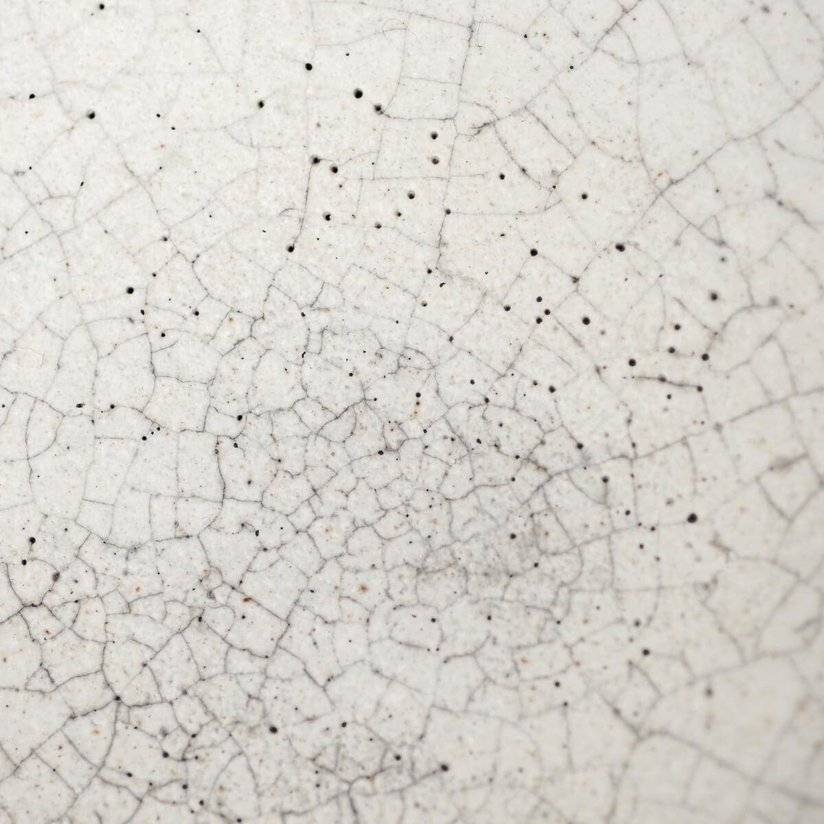 Macro shot of interior glaze details highlighting handcrafted texture and crackle finish.