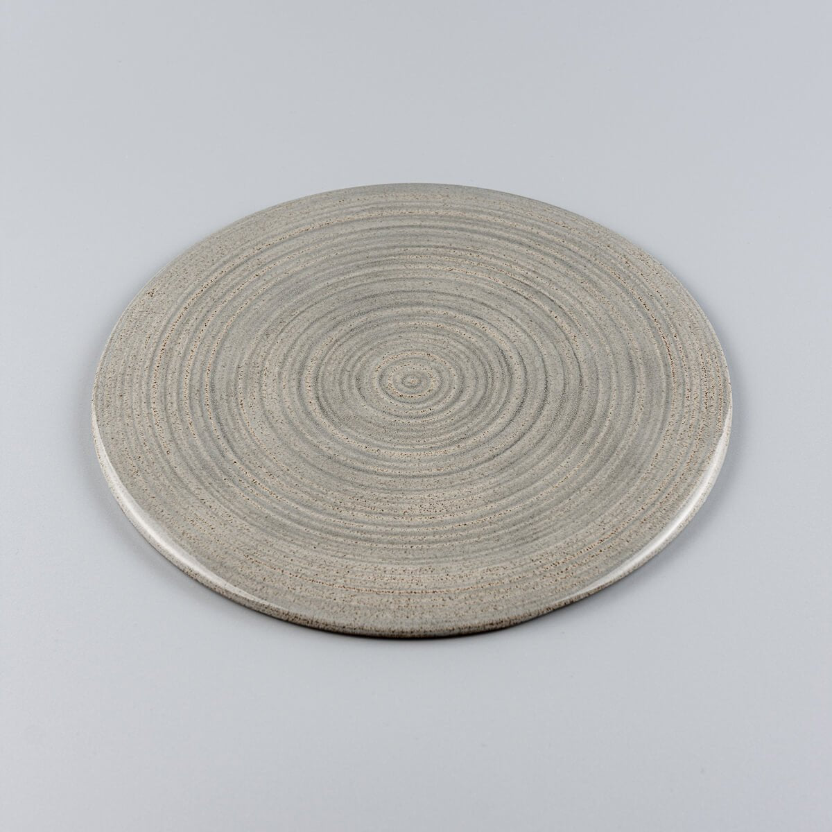 Stackable handmade plate in stoneware clay, minimalist style for restaurant use.