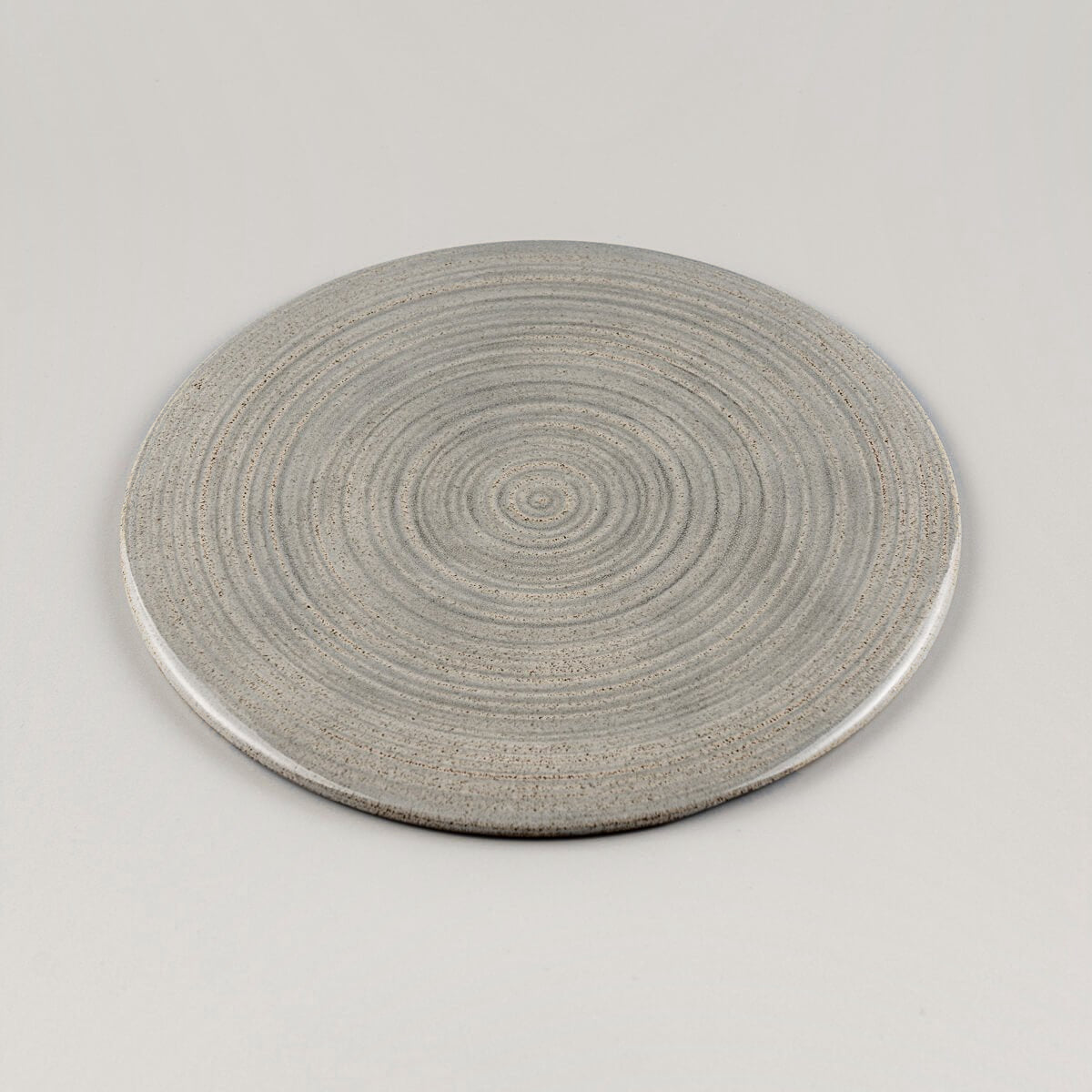 Stackable handmade plate in stoneware clay, minimalist style for restaurant use.