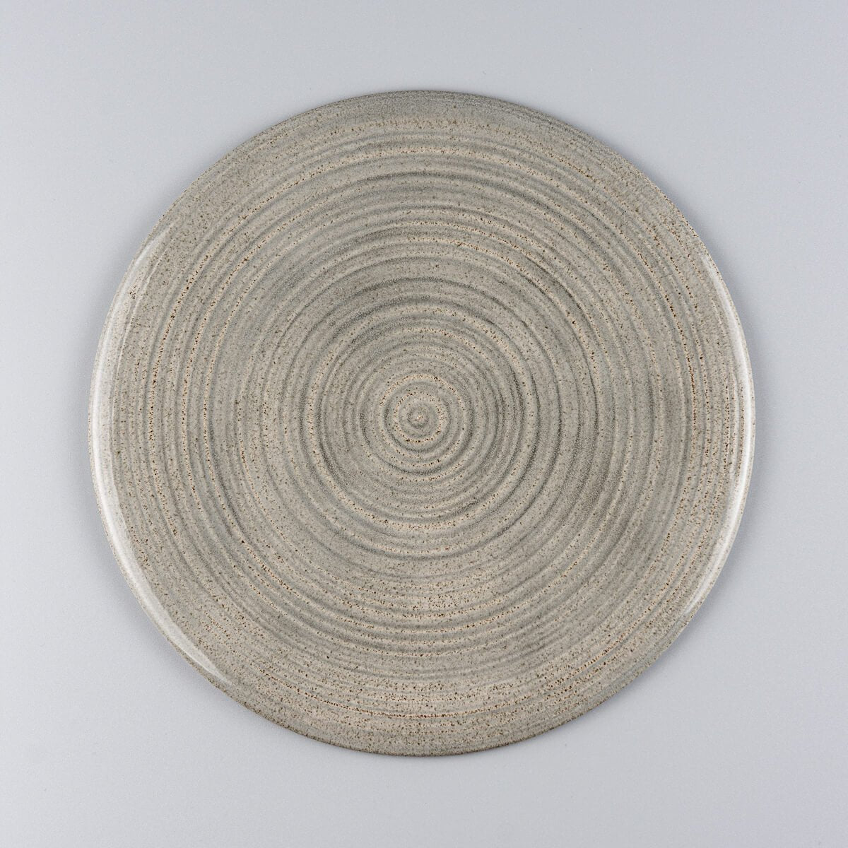 Flat handmade ceramic plate with glossy gray glaze, crafted for fine dining presentation.