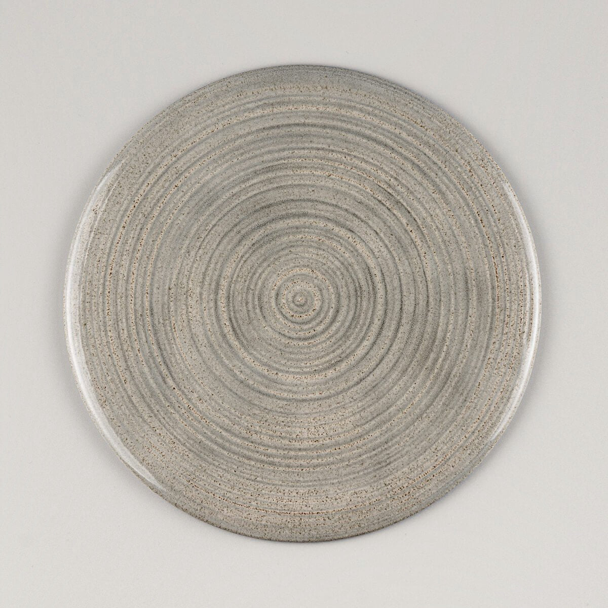 Flat handmade ceramic plate with glossy gray glaze, crafted for fine dining presentation.