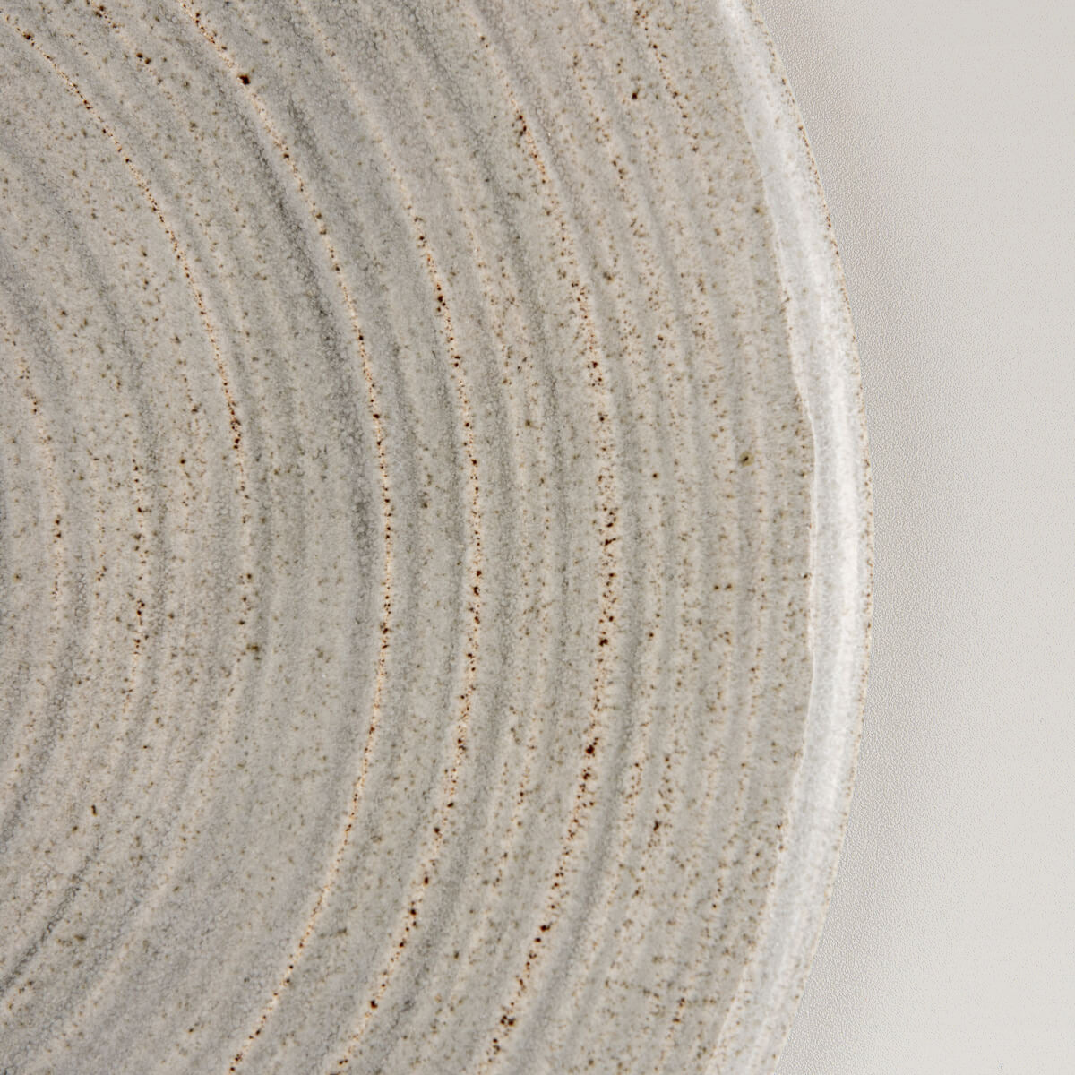 Side view of handmade flat ceramic tableware for elegant food styling.
