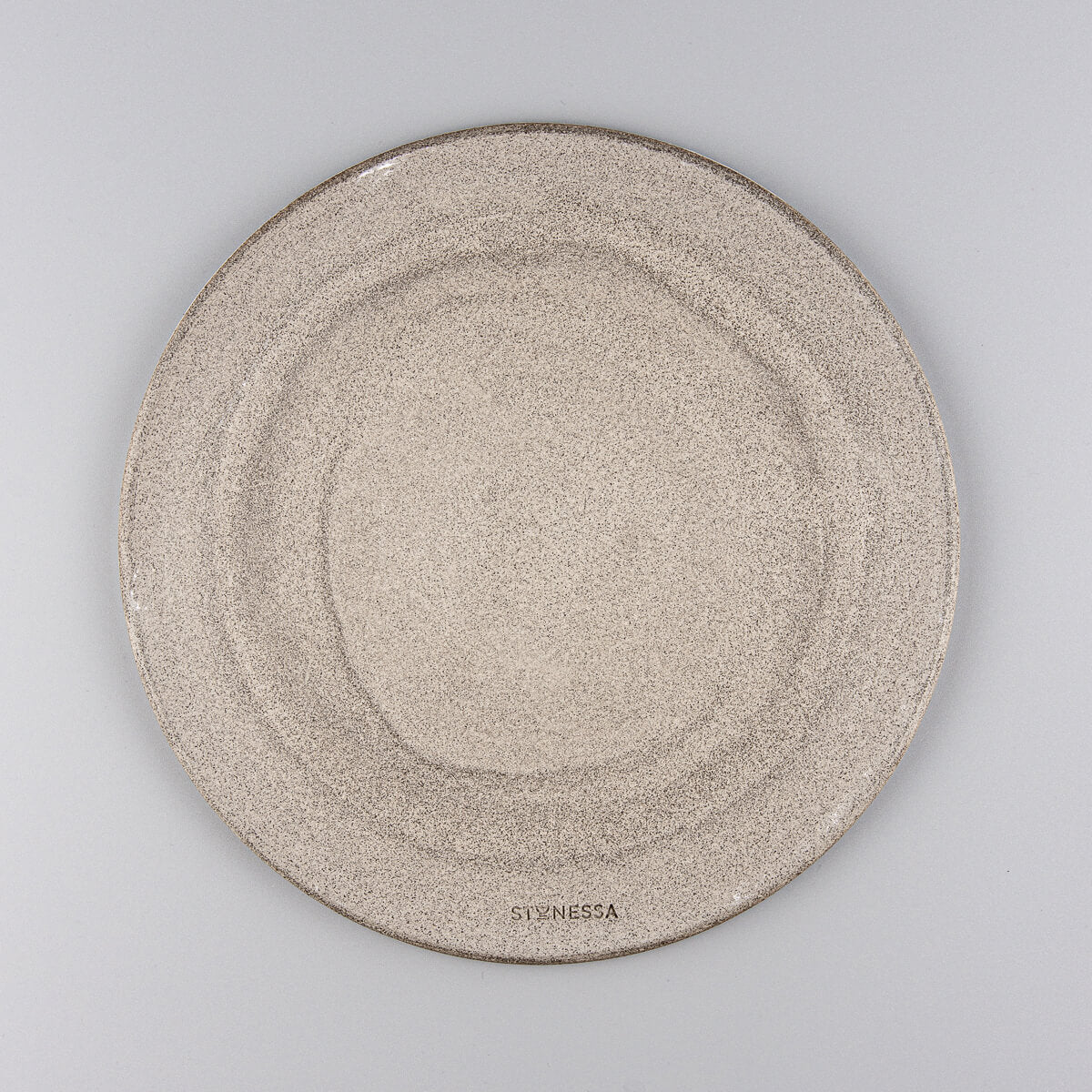 Top view of modern ceramic plate with circular throwing marks and matte finish.