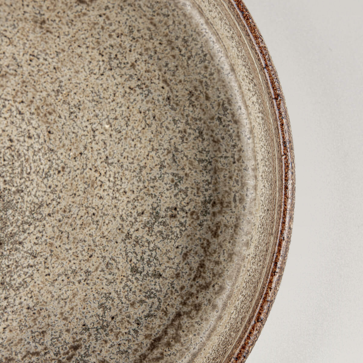 Close-up of textured ceramic surface showing handcrafted matte glaze and artisanal charm.