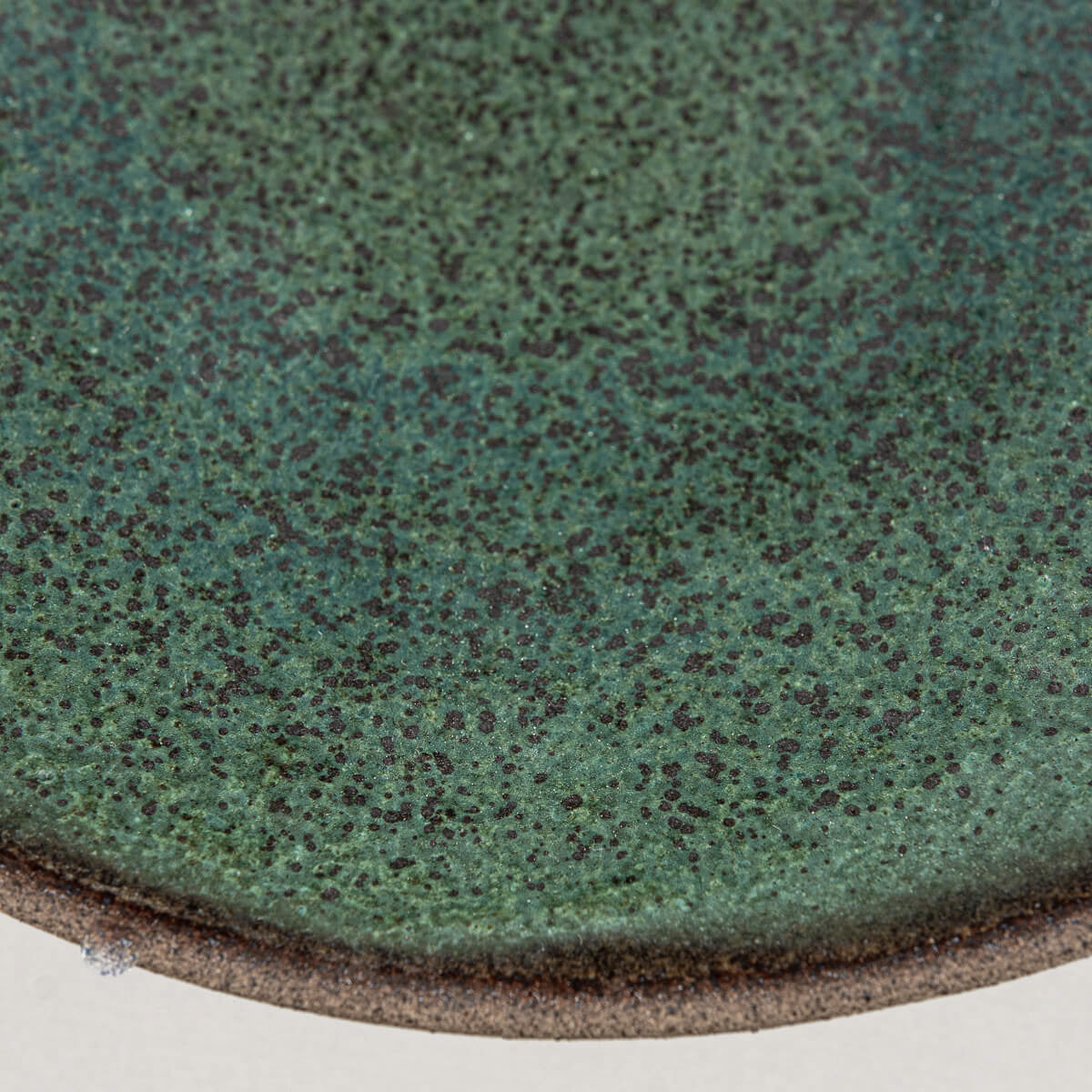 Speckled ceramic surface showing unique handcrafted glaze for stylish culinary use.