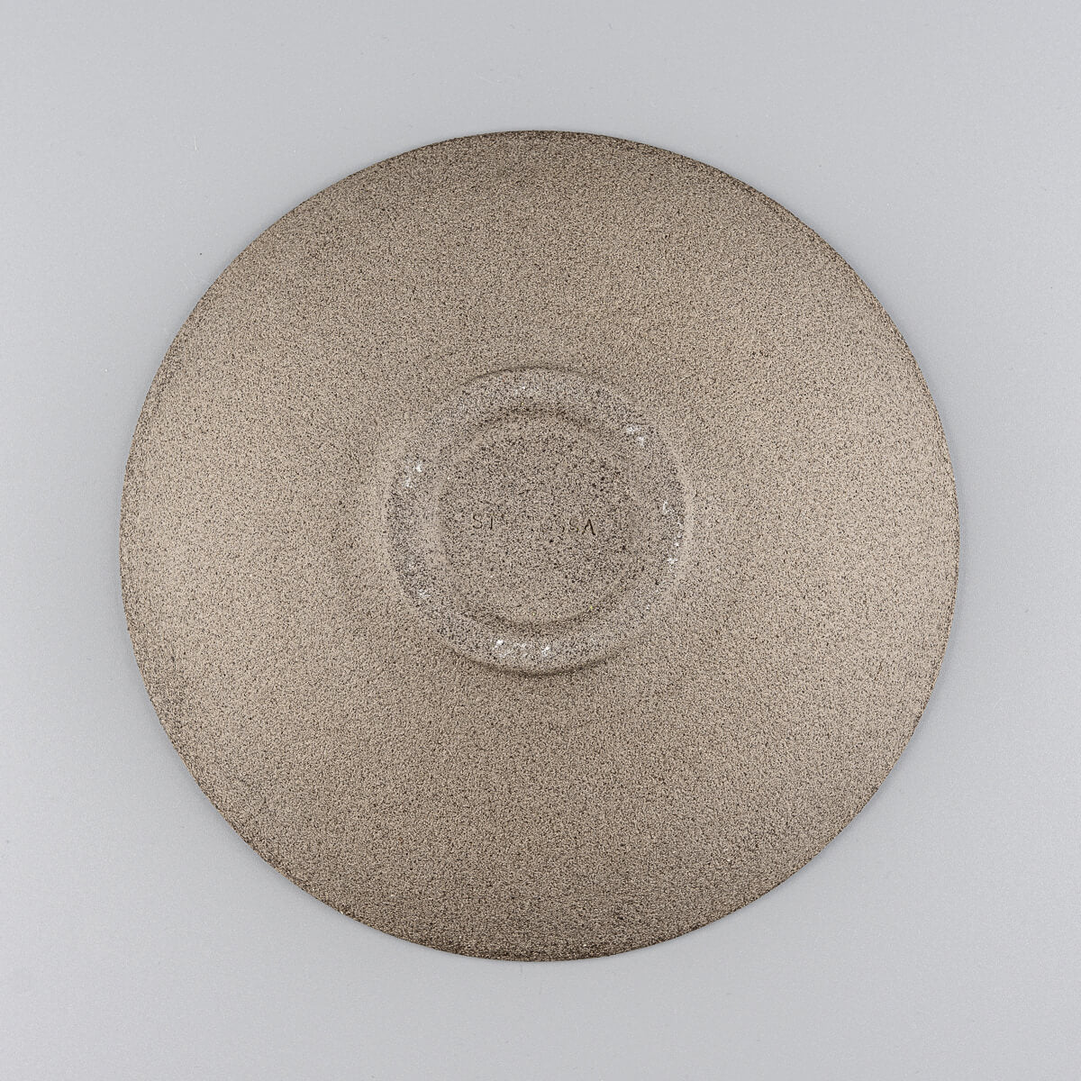 Unfinished clay underside of stoneware plate ideal for home, restaurant, or gallery settings.