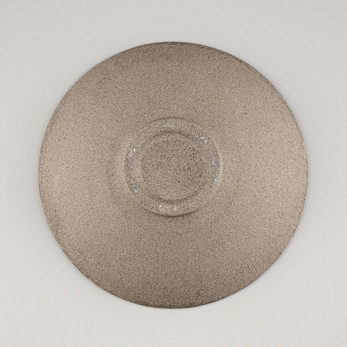 Unfinished clay underside of stoneware plate ideal for home, restaurant, or gallery settings.