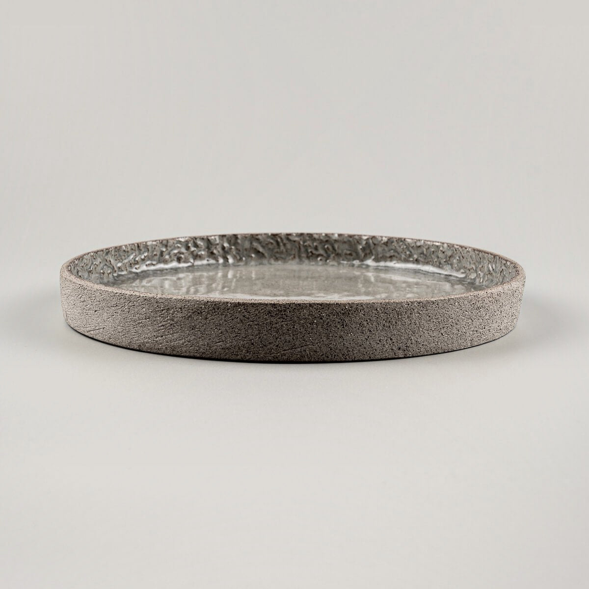 Side view of luxury ceramic dinner plate with straight vertical edge for fine dining presentation.