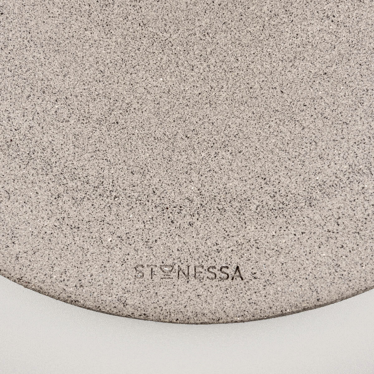 Bottom of unglazed dark stoneware showing handmade craftsmanship and raw finish.