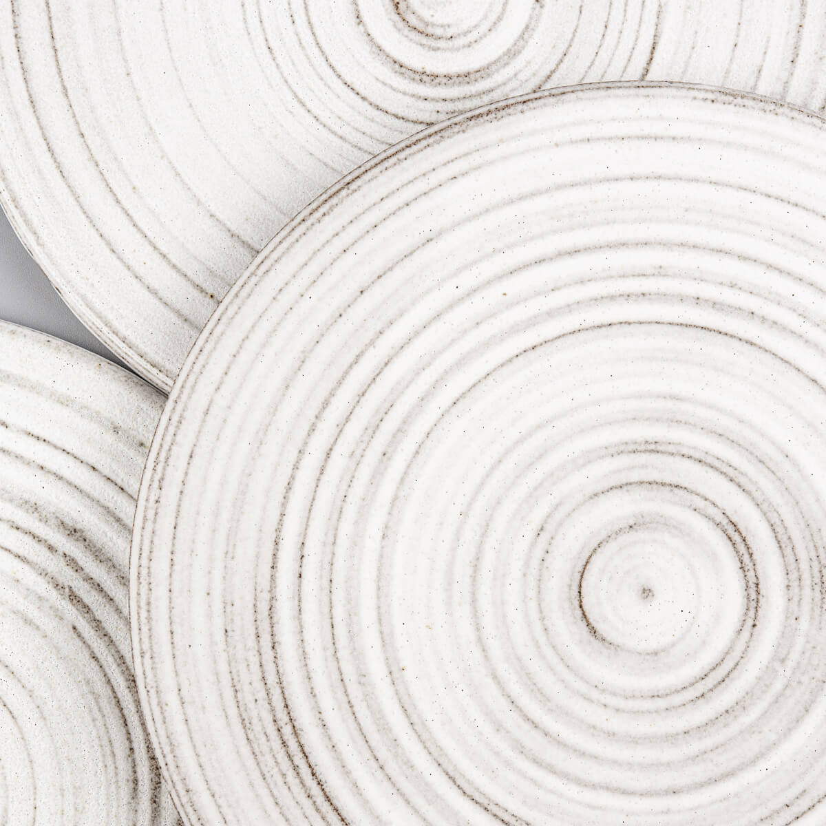 Handcrafted stoneware plates with white glaze, designed for restaurant service.