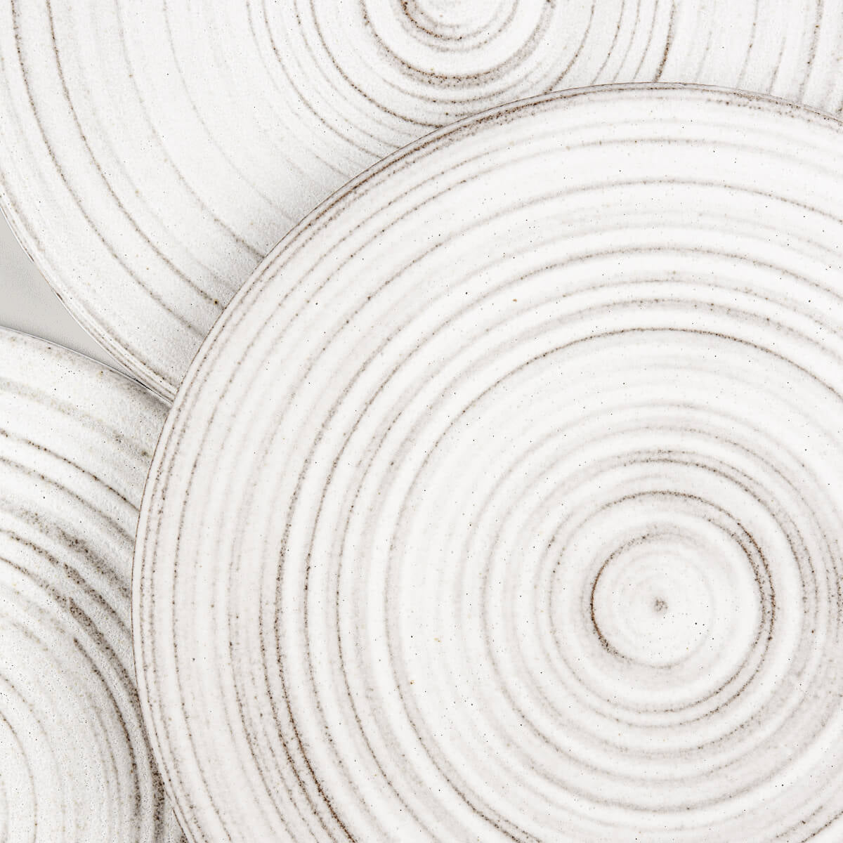 Handcrafted stoneware plates with white glaze, designed for restaurant service.