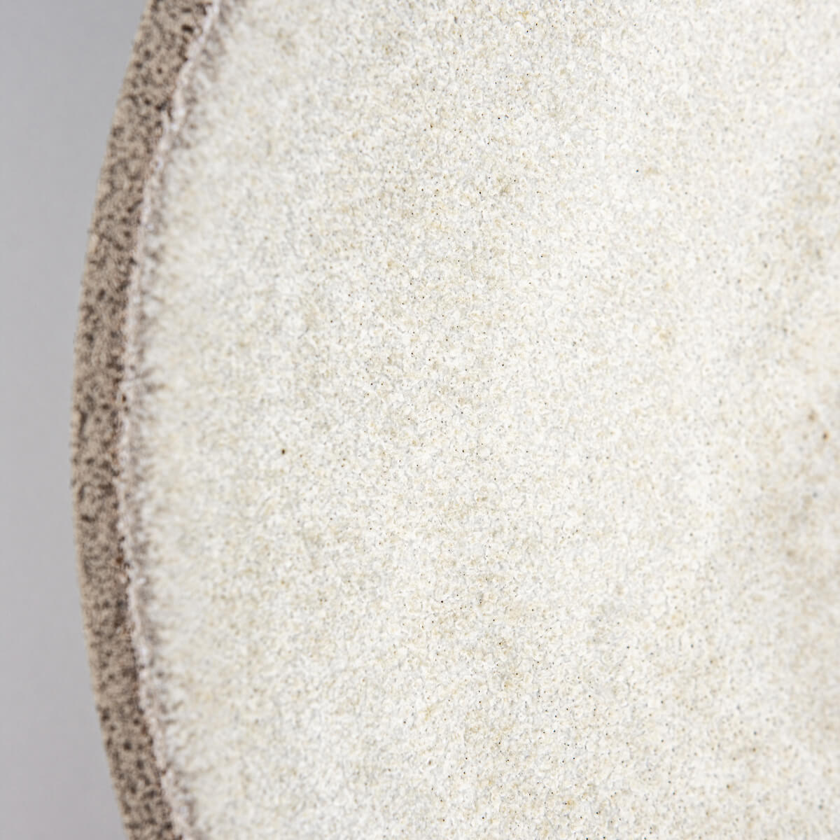 Shallow ceramic plate with matte white glaze, ideal for contemporary food styling.