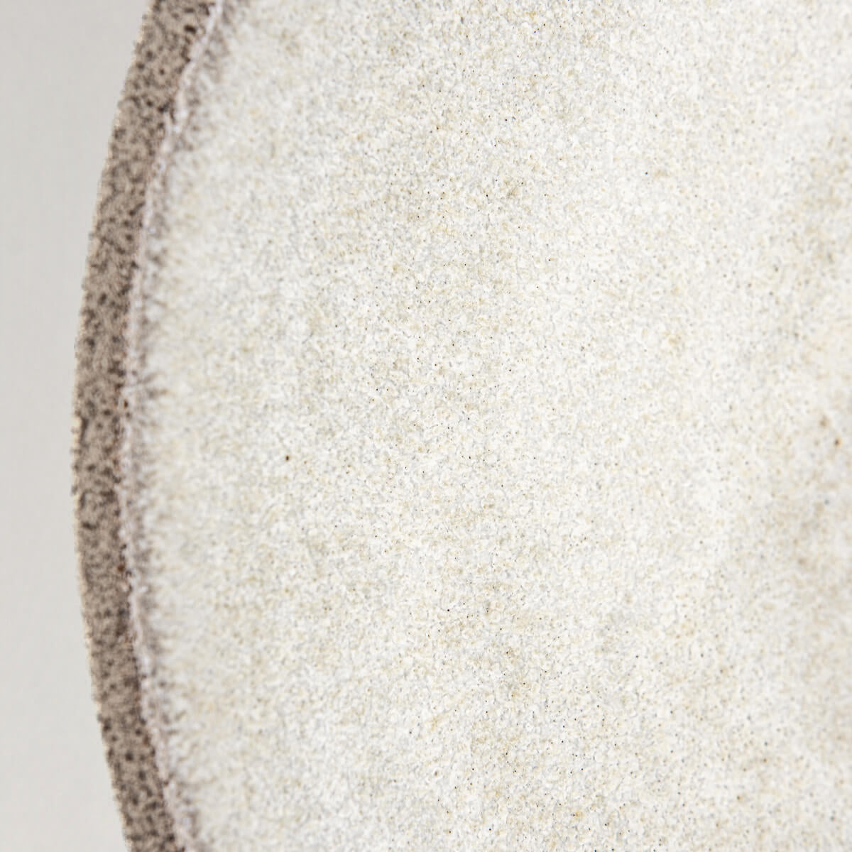 Shallow ceramic plate with matte white glaze, ideal for contemporary food styling.