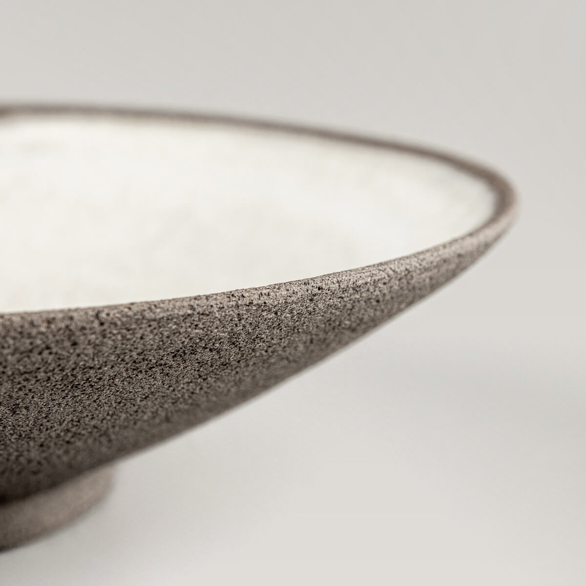 Fine dining plate with matte glaze and rustic clay base for unique serving moments.