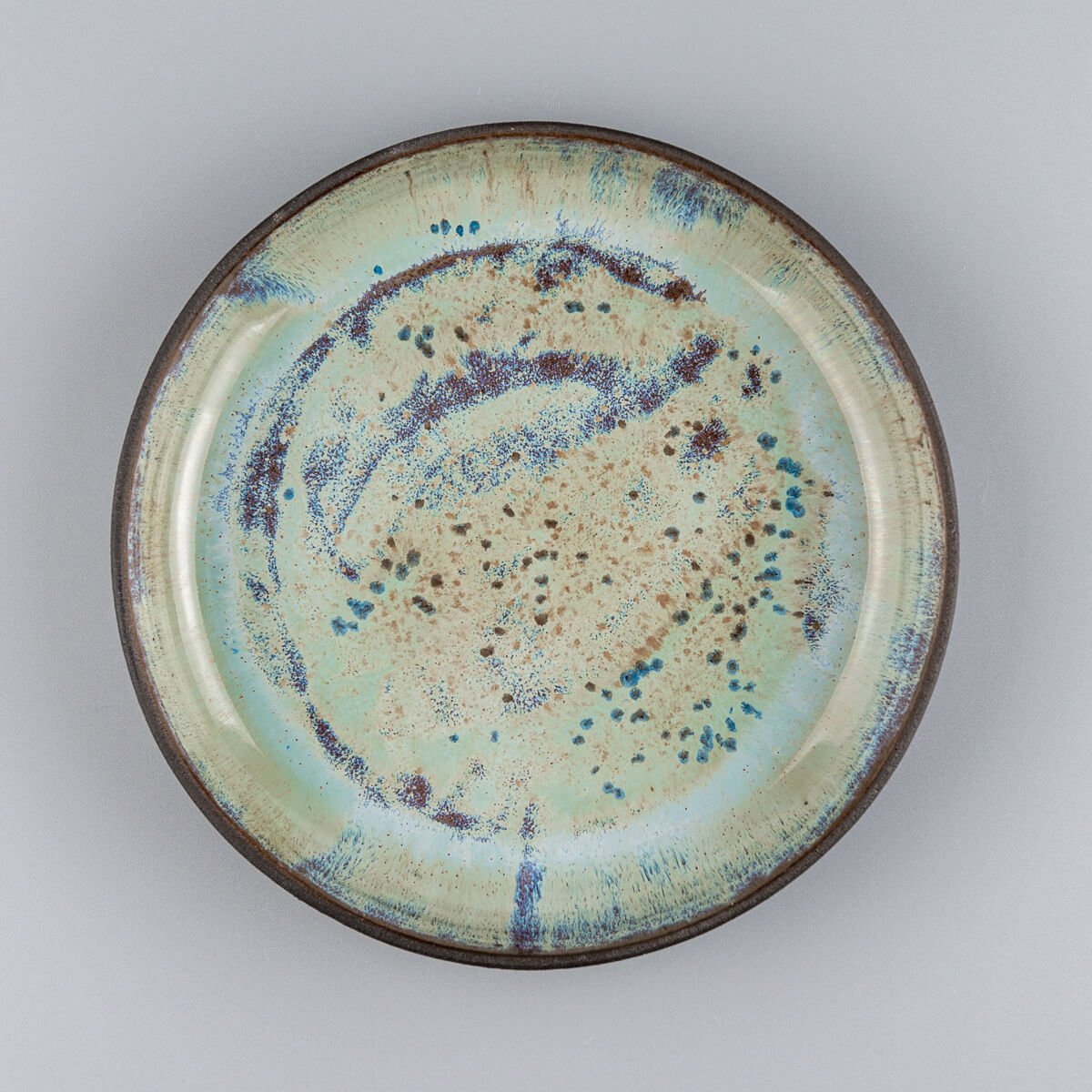 Unique ceramic plate with glossy galactic glaze for fine dining and collectible tableware.