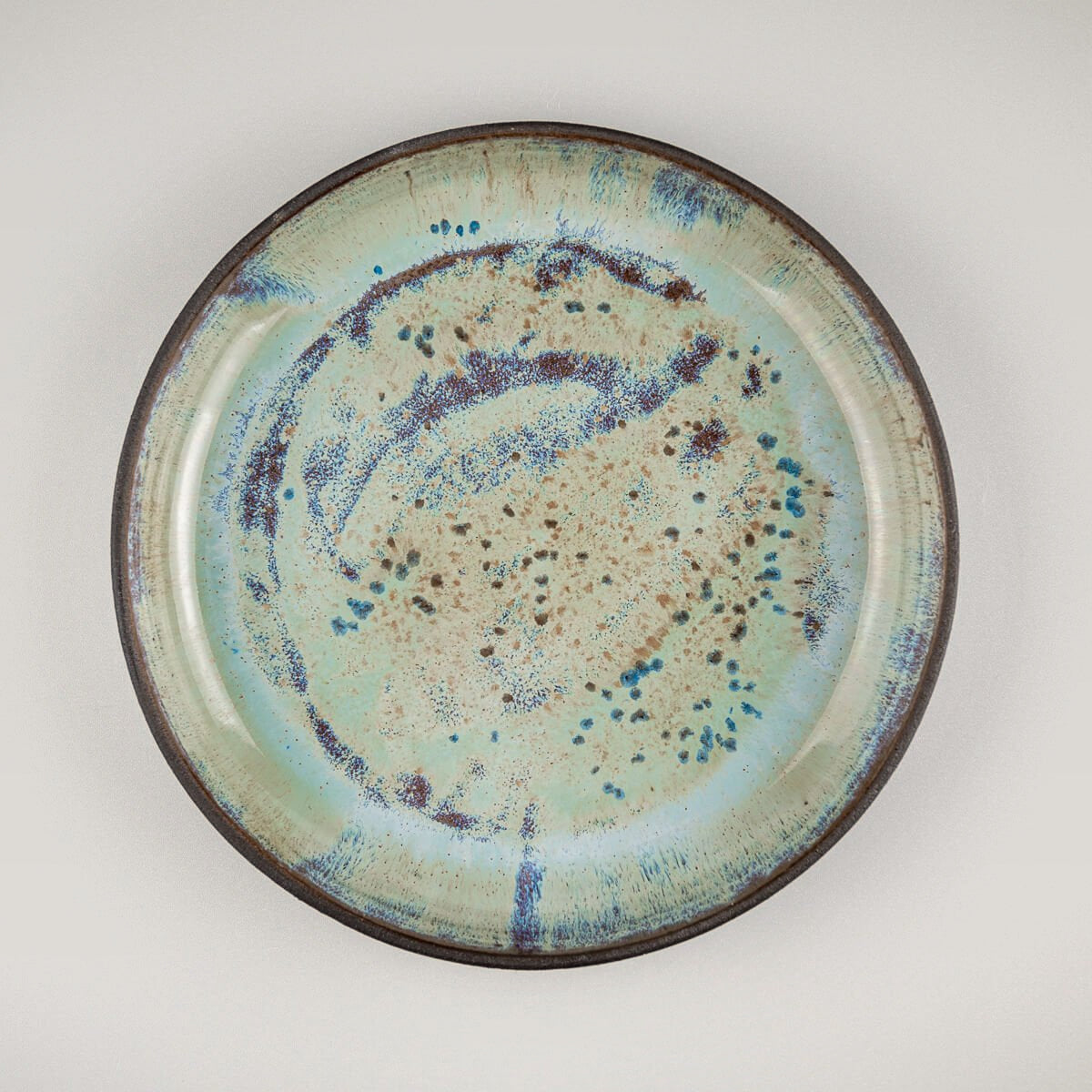 Unique ceramic plate with glossy galactic glaze for fine dining and collectible tableware.