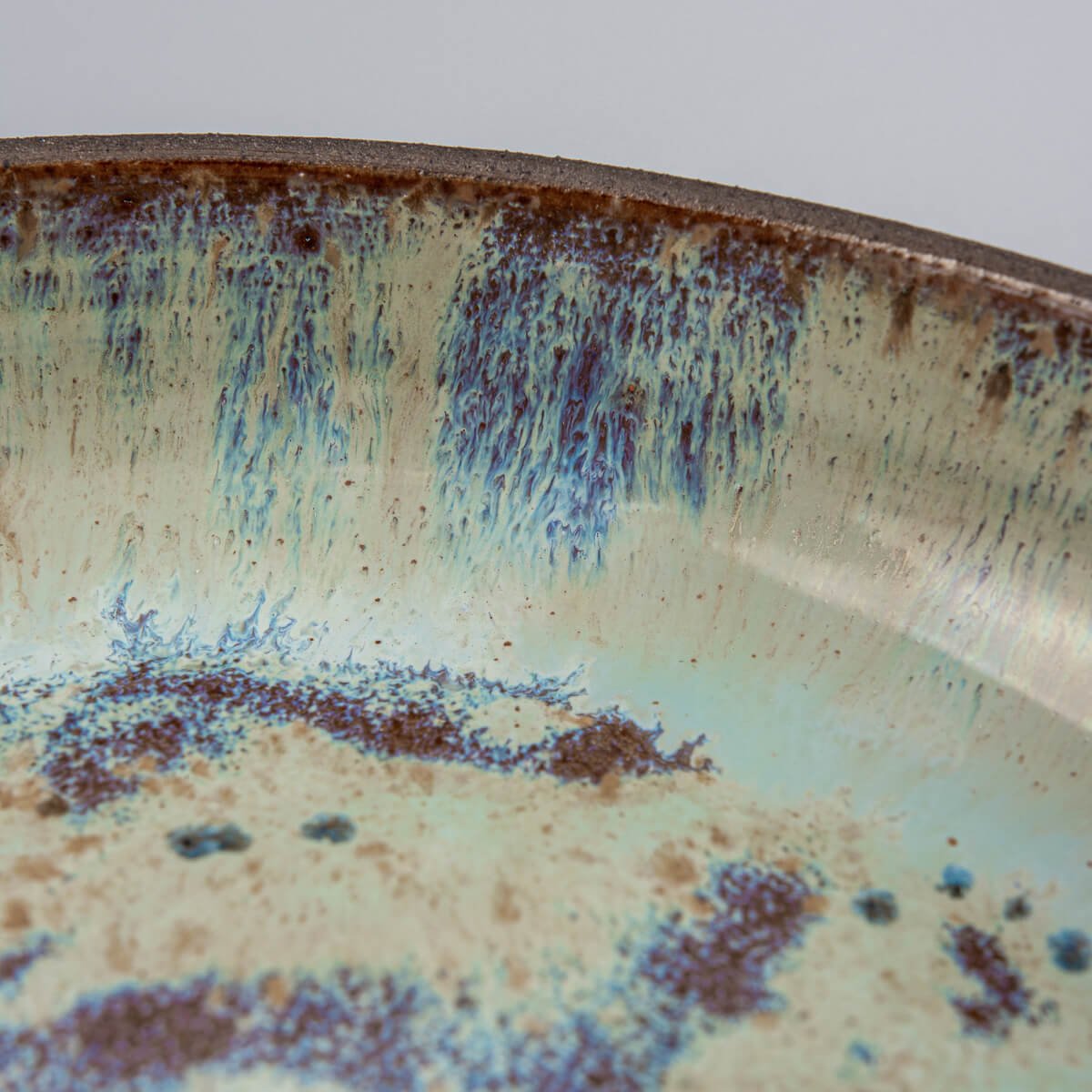 Glossy glaze texture with cosmic-inspired finish on designer ceramic plate.