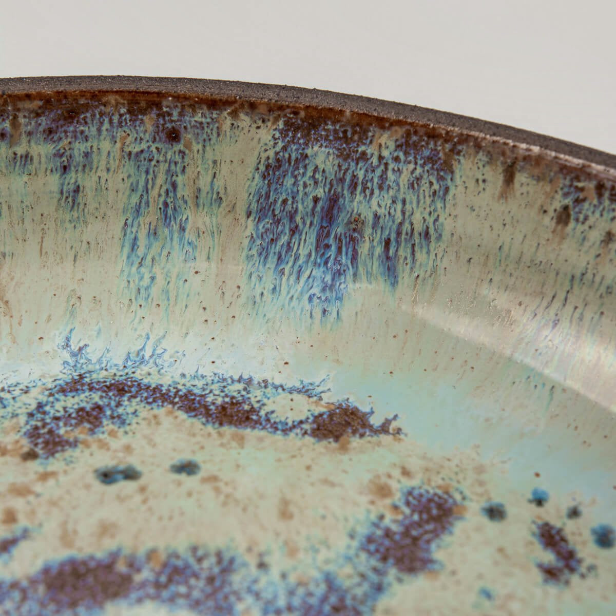 Glossy glaze texture with cosmic-inspired finish on designer ceramic plate.