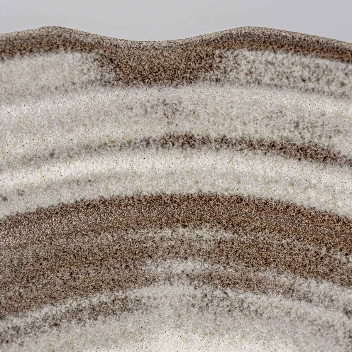 Glazed interior close-up highlighting artisan craftsmanship and natural stoneware variation.