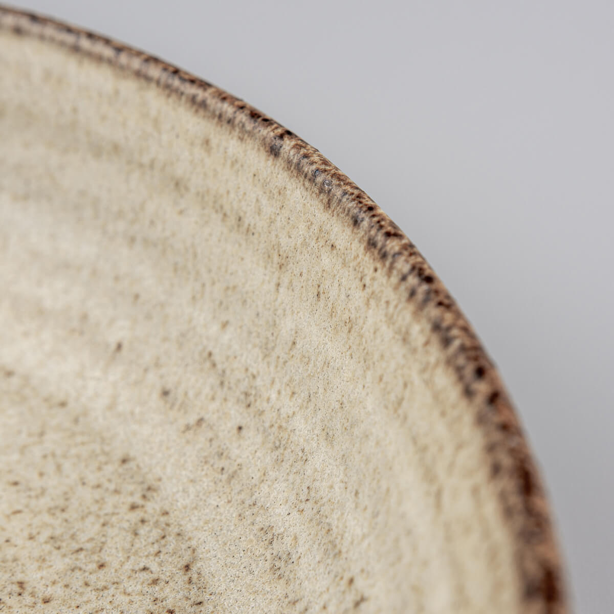 Organic handmade plate with curved coupe form and durable fine dining finish.