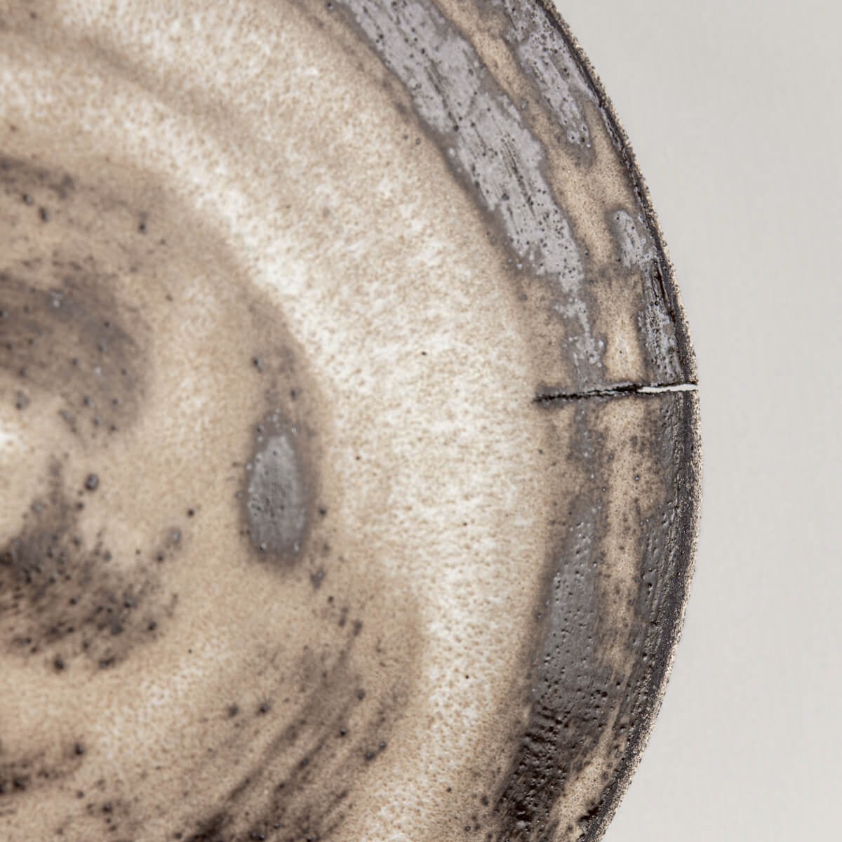 Close-up of rustic glaze with matte finish and organic texture for decor collectors.