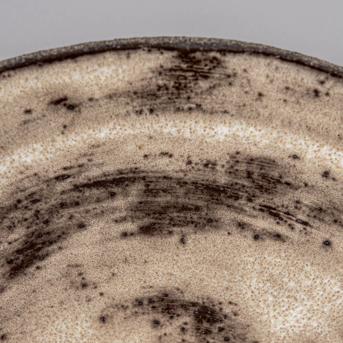 Organic shaped ceramic plate ideal for rustic tableware or culinary presentation.