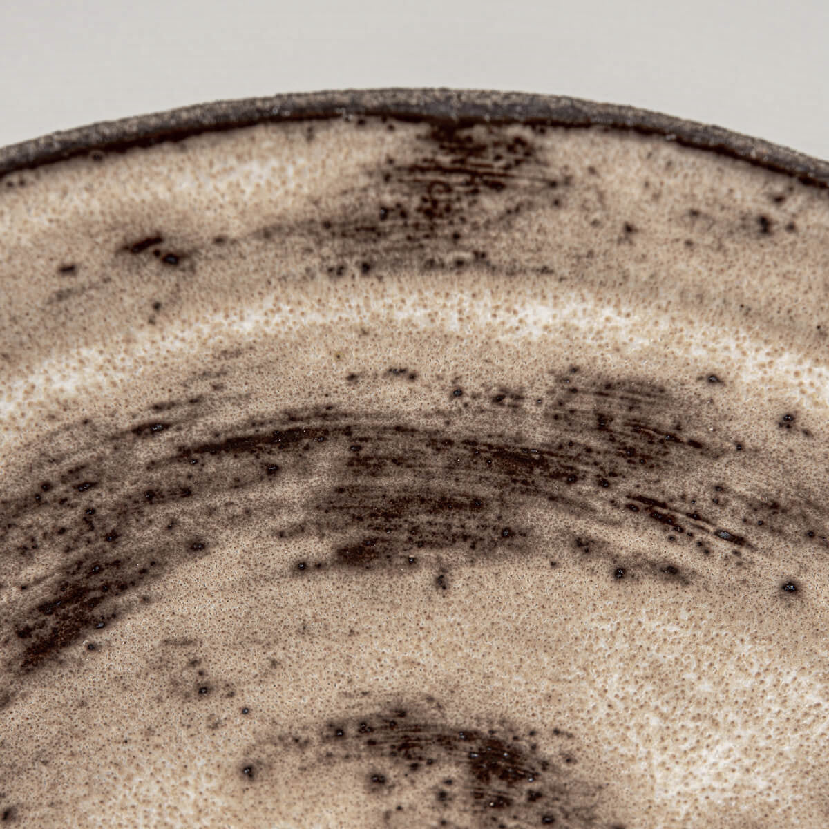Organic shaped ceramic plate ideal for rustic tableware or culinary presentation.