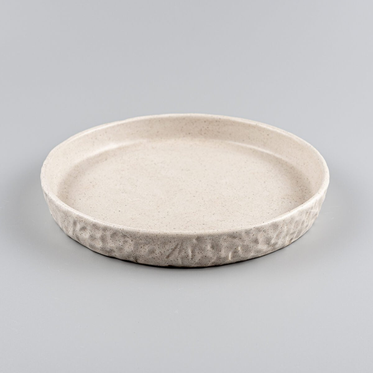 Textured edge stoneware plate for boutique hotel or home table settings.