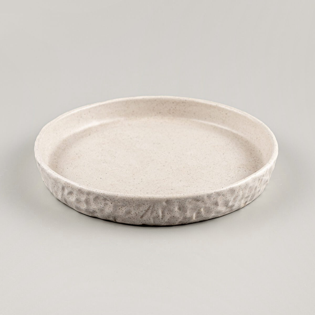 Textured edge stoneware plate for boutique hotel or home table settings.