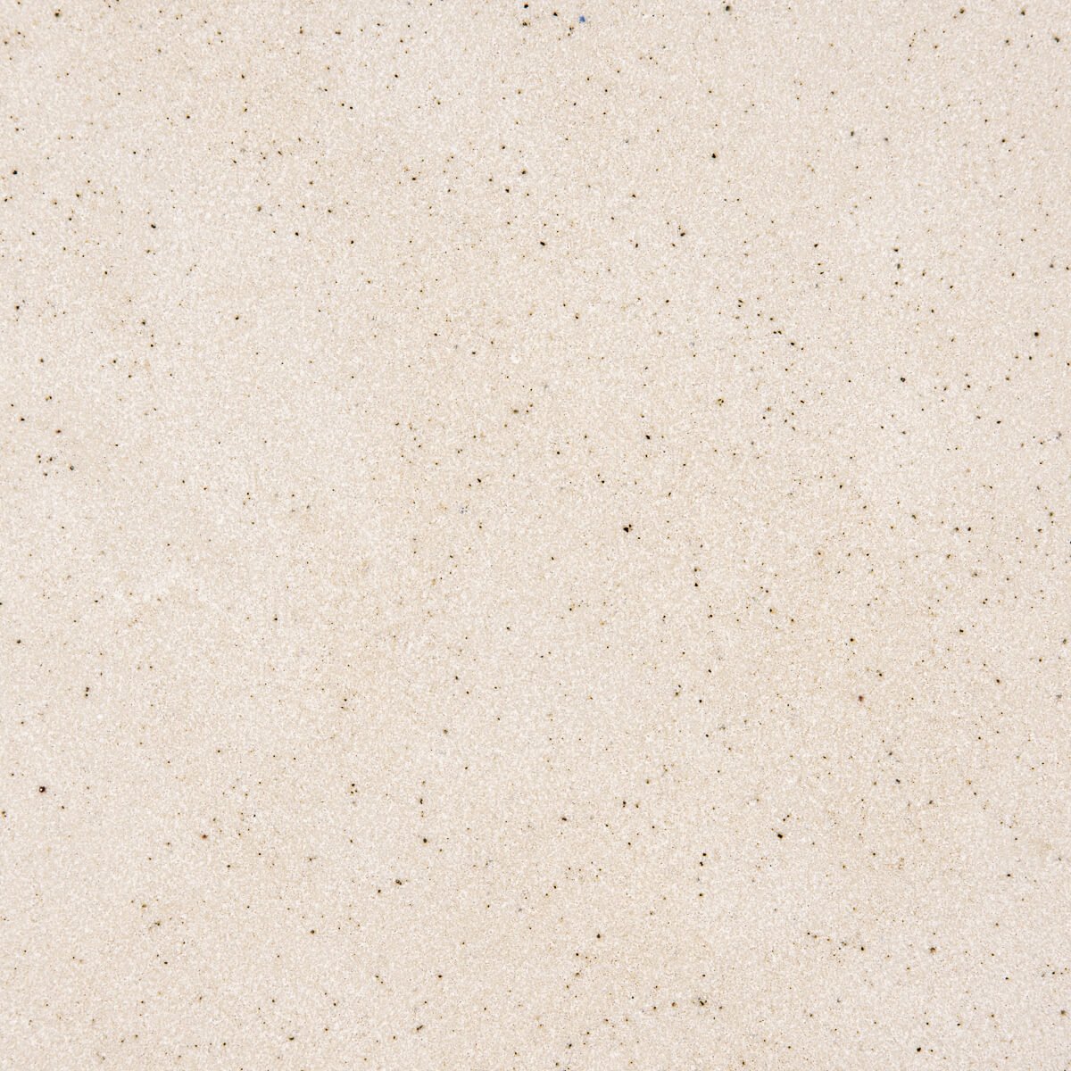 Close-up of durable matte beige glaze on artisan stoneware dessert plate.