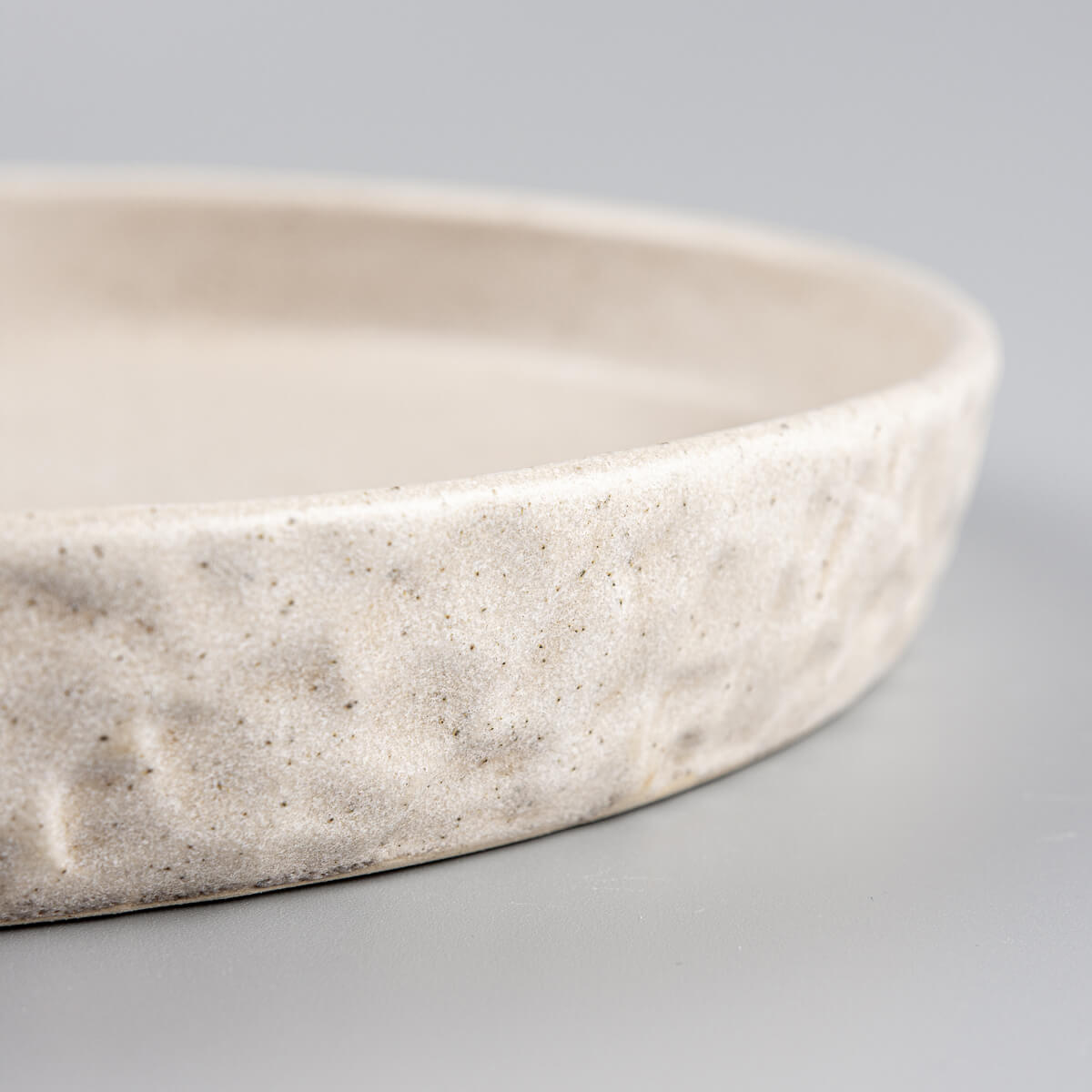 Handmade stoneware plate with durable finish, perfect for culinary display.