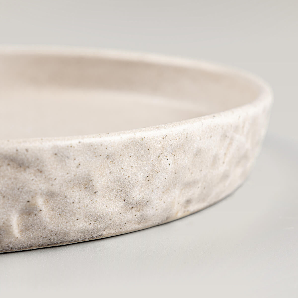 Handmade stoneware plate with durable finish, perfect for culinary display.