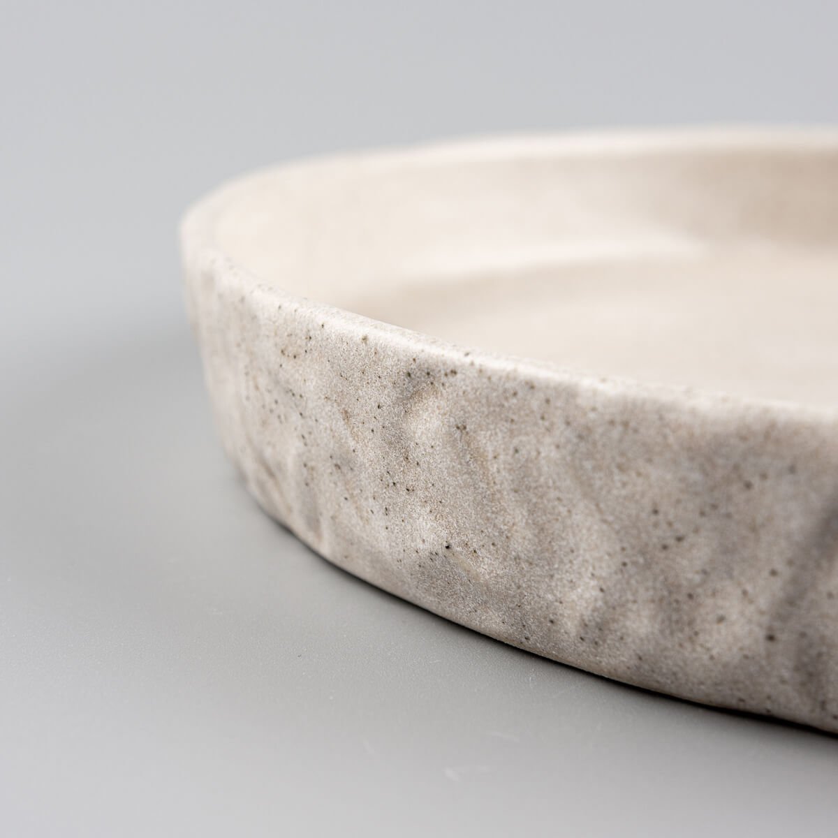 Elegant ceramic plate with minimalist shape for restaurants or collectors.