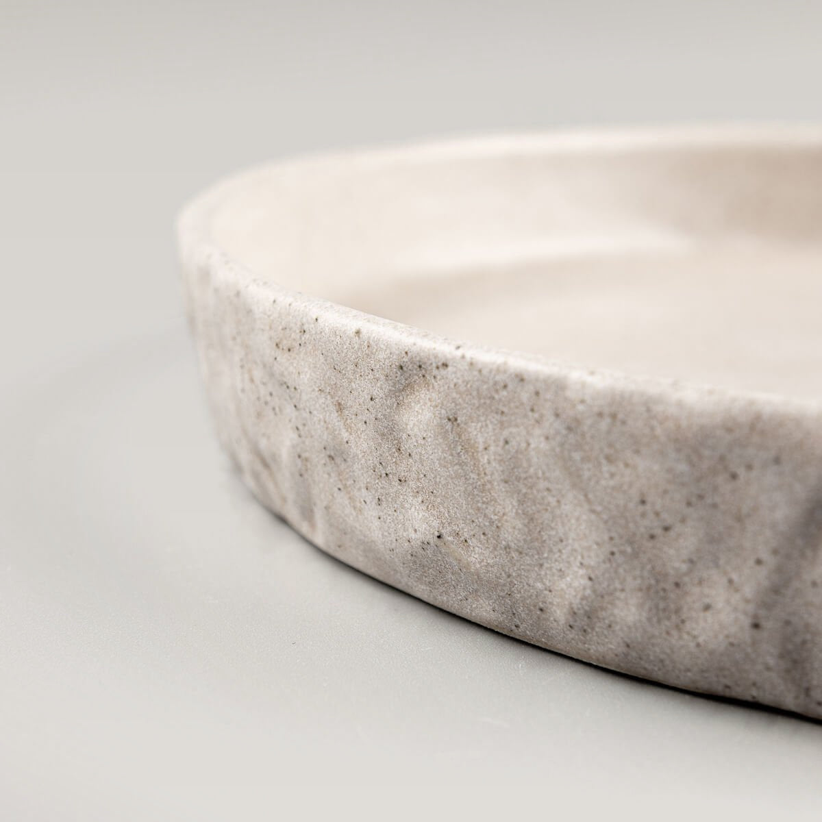 Elegant ceramic plate with minimalist shape for restaurants or collectors.